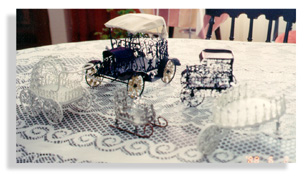 Tin Lizzy, tiny Tin Lissy, wheel barrel, Santa sleigh, and baby carriage from tin cans